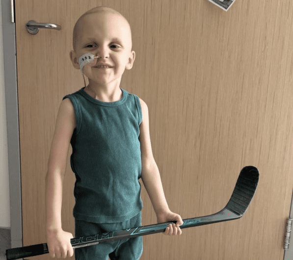 Mavrik holding his hockey stick
